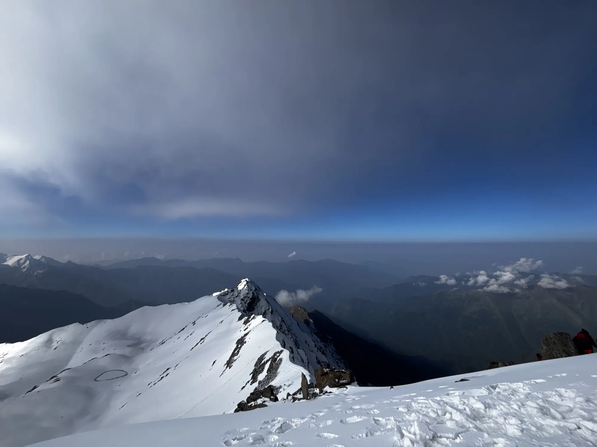 Trekkers on a Himalayan summit ridge at sunrise